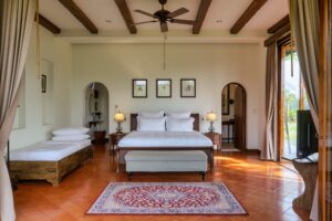 River Kwai House - Master bedroom with terracotta floor and beamed ceiling